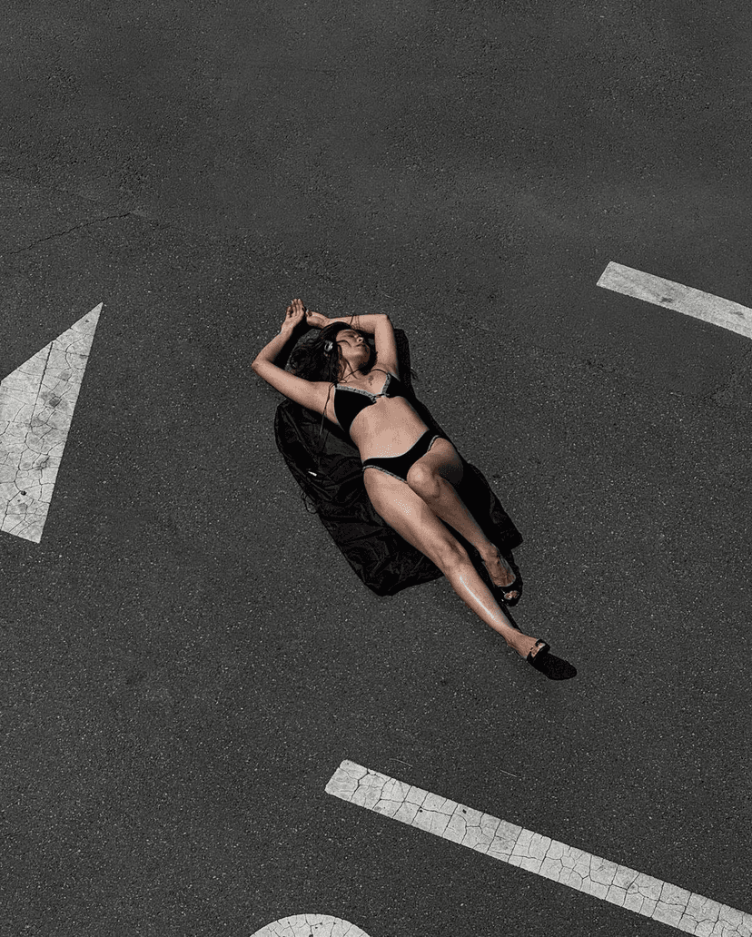 model laying on the road